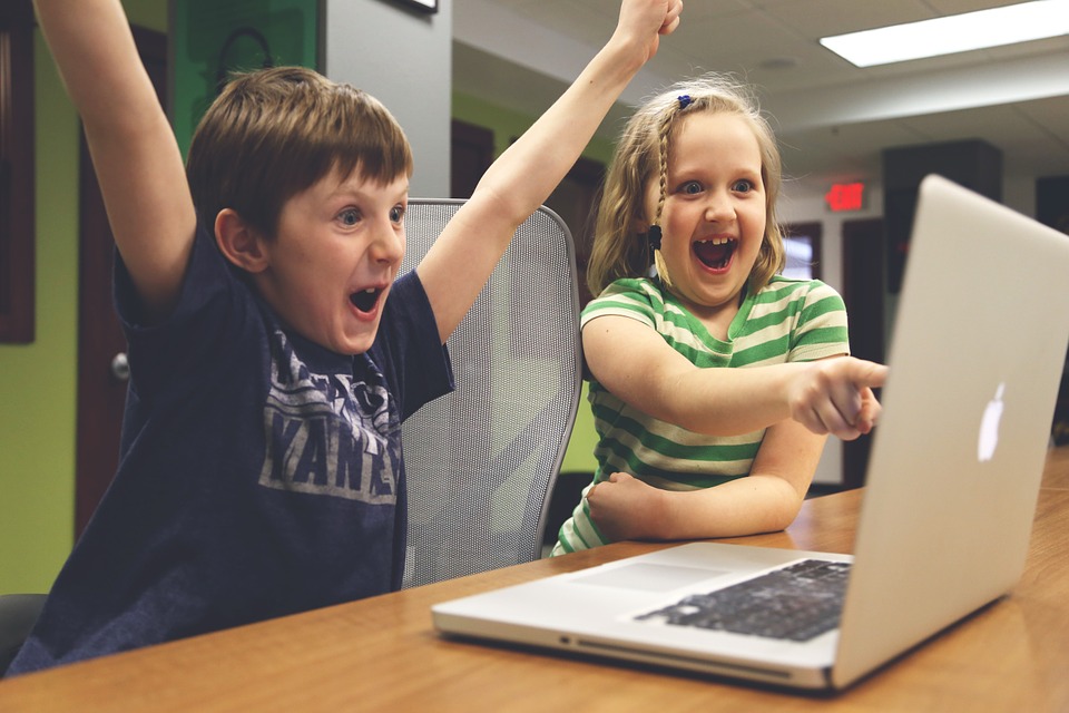 Happy kids looking at the laptop